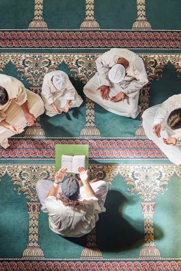 Men Reading Quran